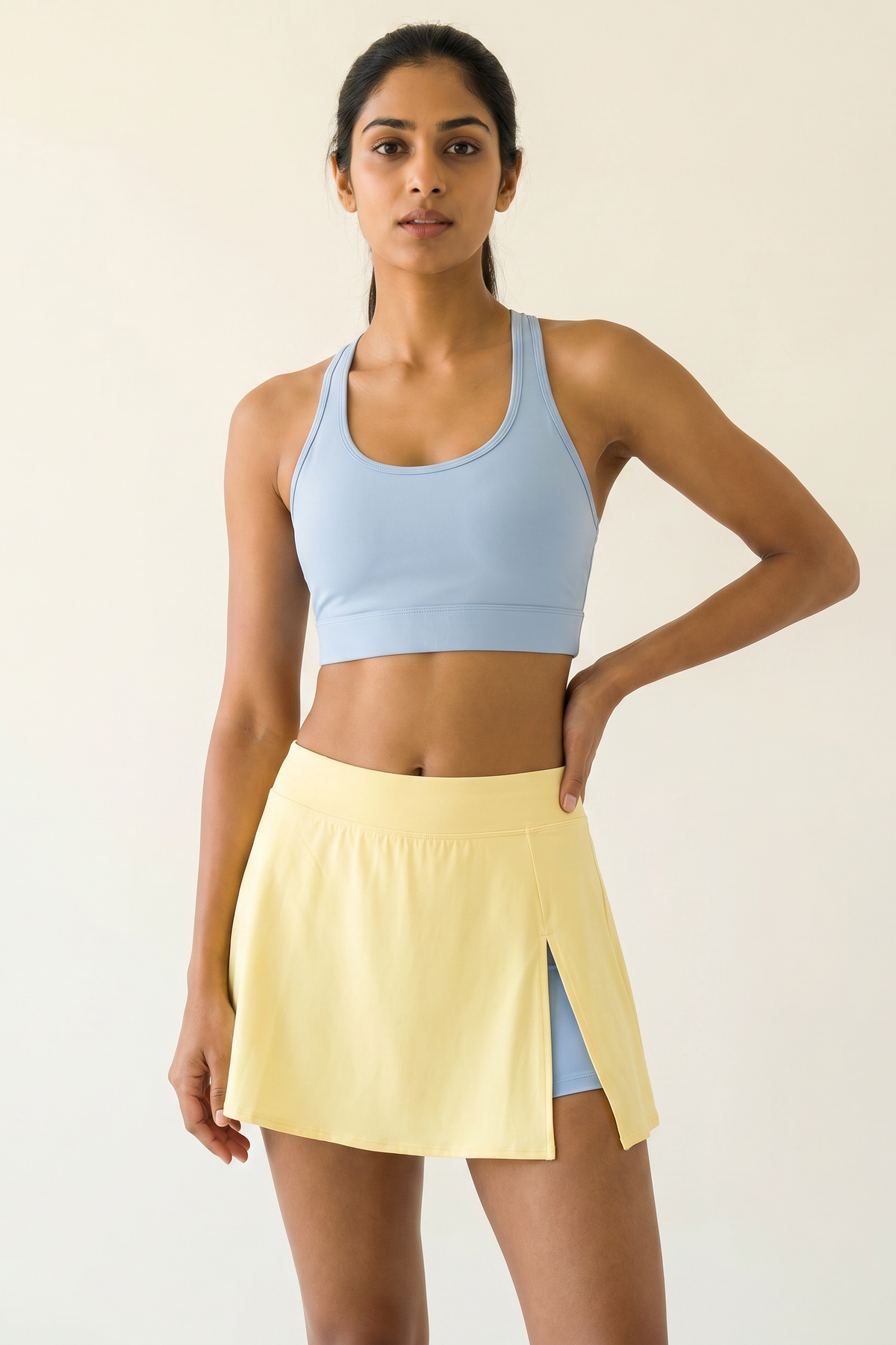 Aurora Sunray Skort Set — Horizon Blue racerback bra with butter yellow side-slit skort on Indian model