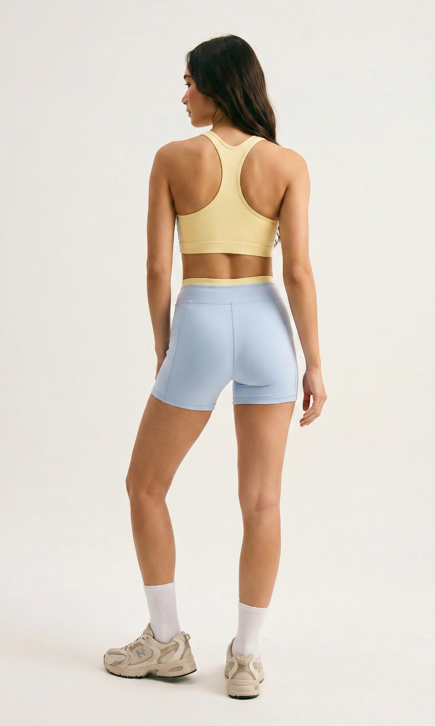 Skyline Reversible Set back view β butter yellow racerback bra reverse and Horizon Blue biker shorts