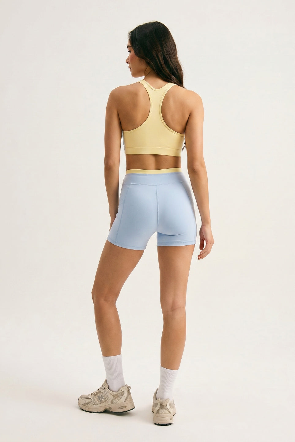 Skyline Reversible Set back view — butter yellow racerback bra reverse and Horizon Blue biker shorts