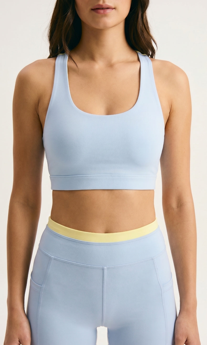 Skyline Reversible Sports Bra closeup β Horizon Blue scoop neck racerback with butter yellow reversible back