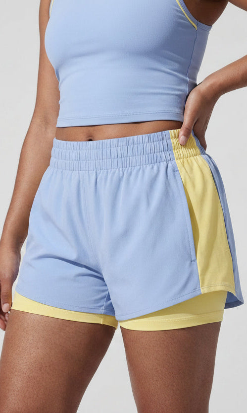Terraloop DualWave Shorts - Close-up of smocked waistband and yellow colorblock panel