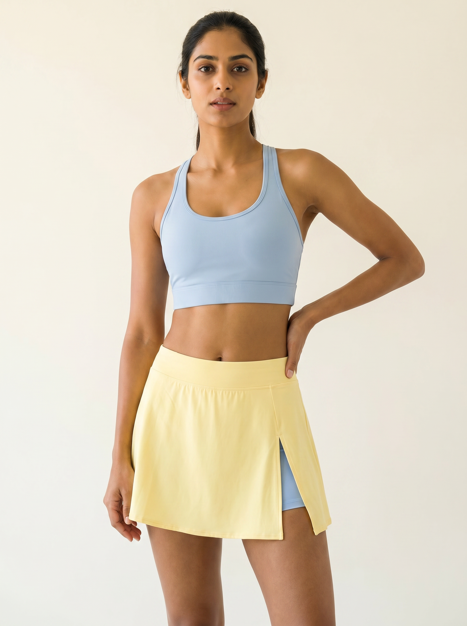 Aurora Sunray Skort Set — Horizon Blue racerback bra with butter yellow side-slit skort on Indian model