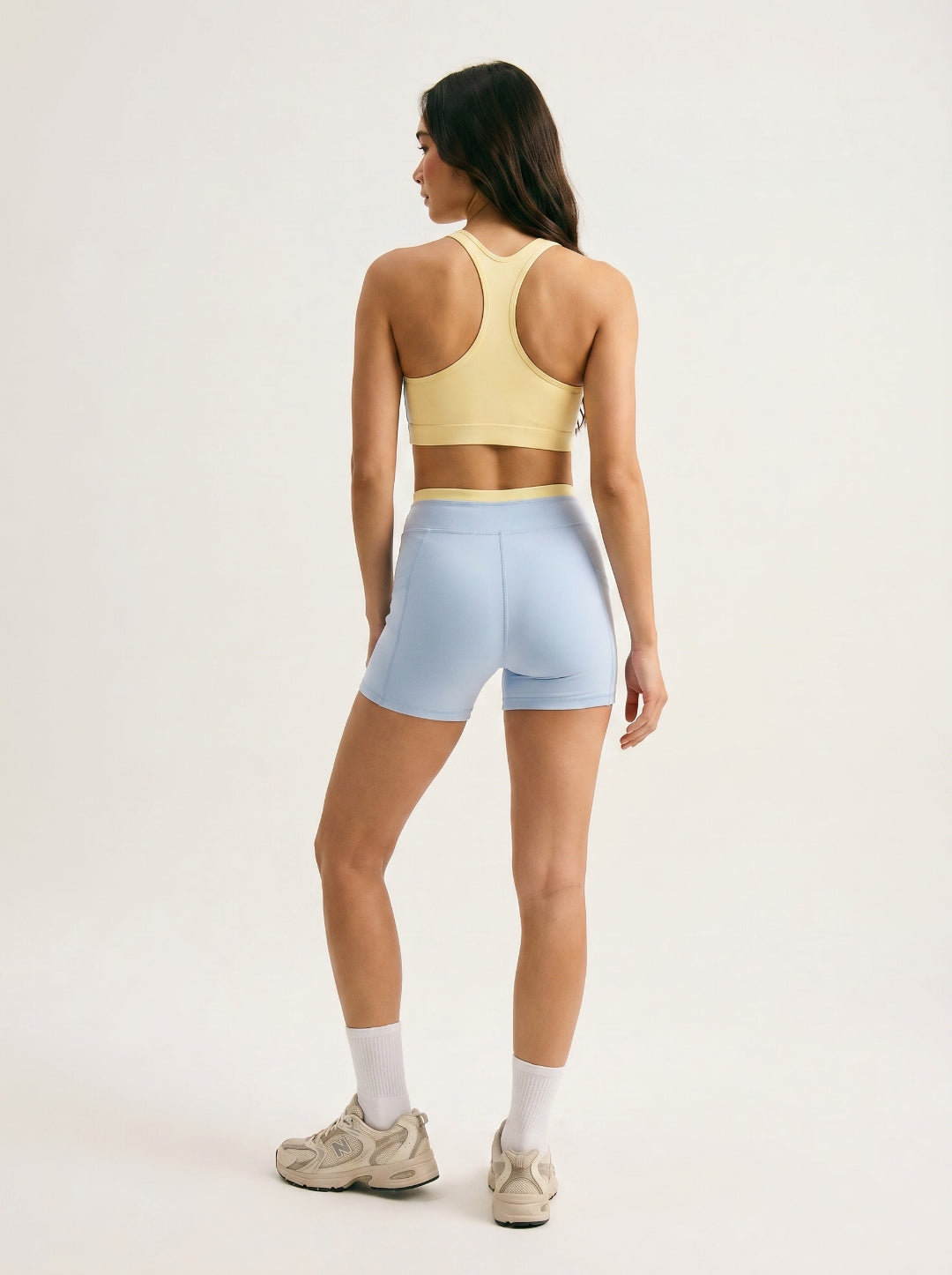 Skyline Reversible Set back view — butter yellow racerback bra reverse and Horizon Blue biker shorts