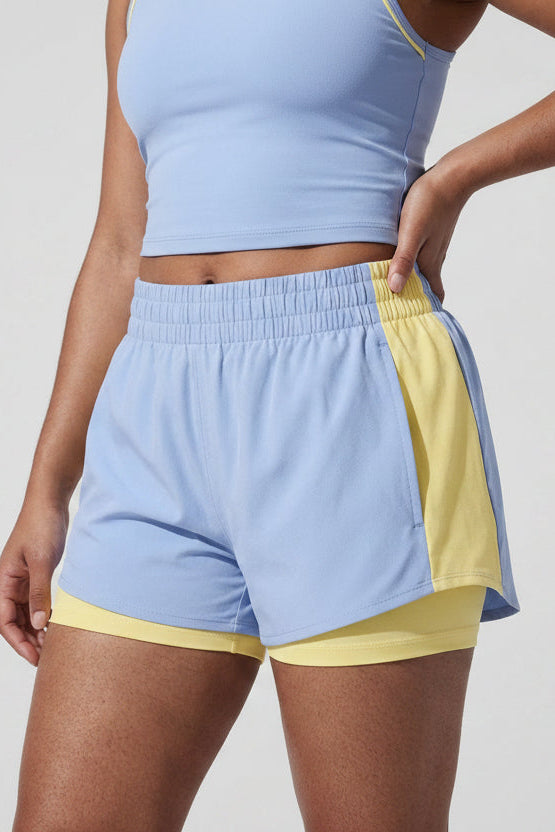 Terraloop DualWave Shorts - Close-up of smocked waistband and yellow colorblock panel